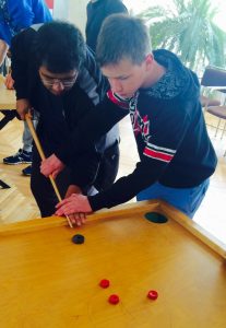 A NSLI-Y participant learns the best method for playing Novuss